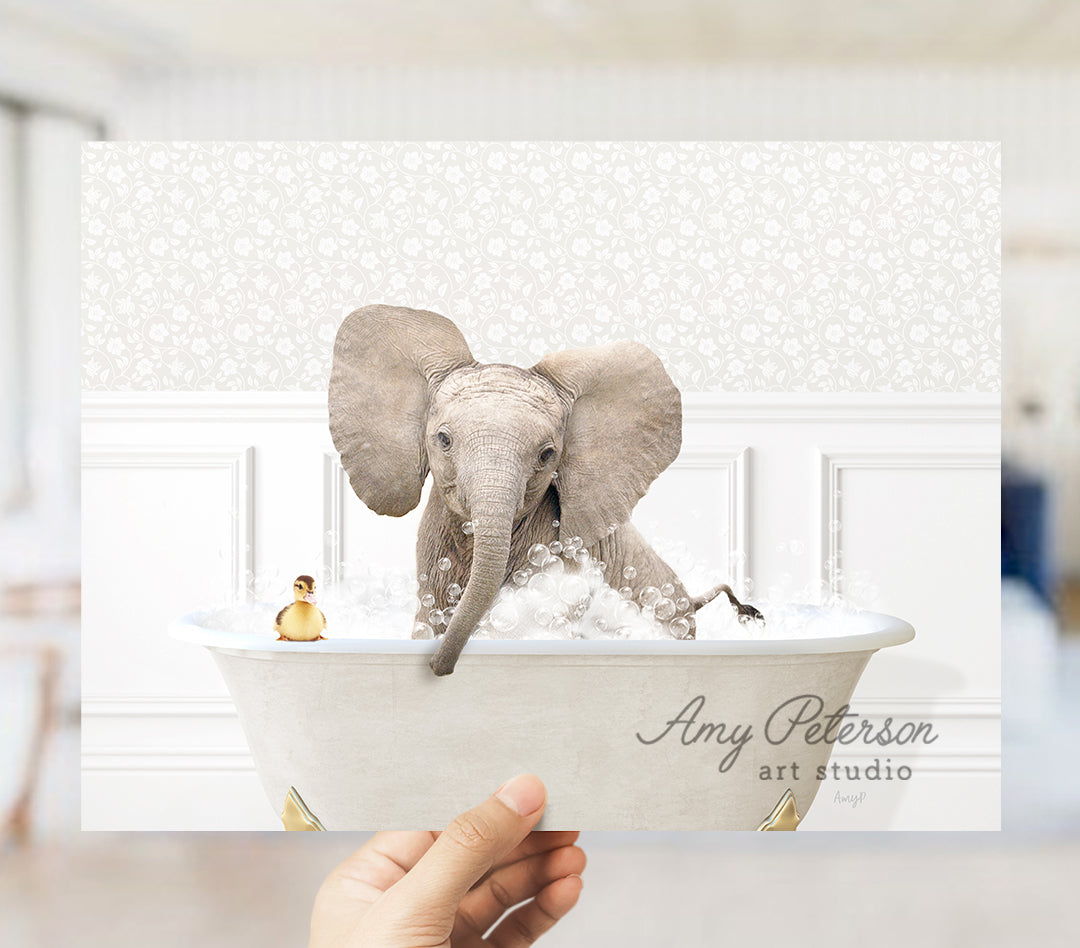 a person holding a picture of an elephant in a bathtub