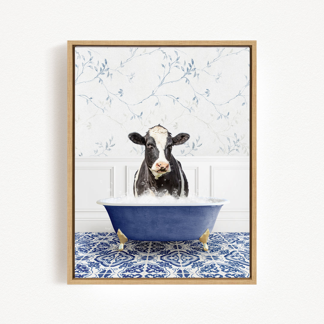A black and white cow is sitting in a blue bathtub filled with water, creating a whimsical and humorous scene.