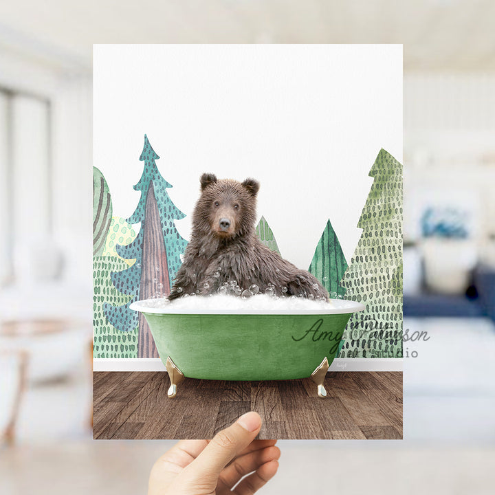 a hand holding up a card with a bear in a bathtub