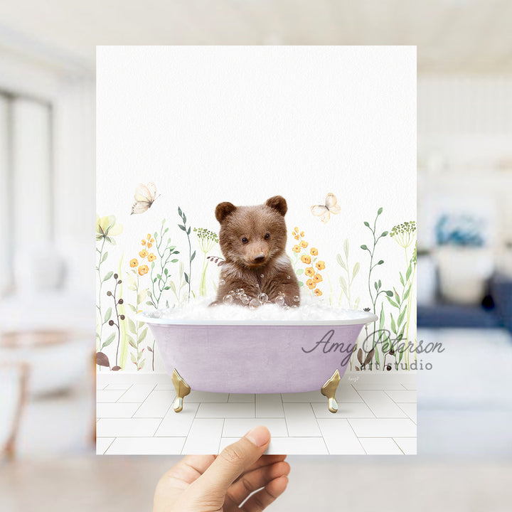 a person holding a card with a picture of a teddy bear in a bathtub