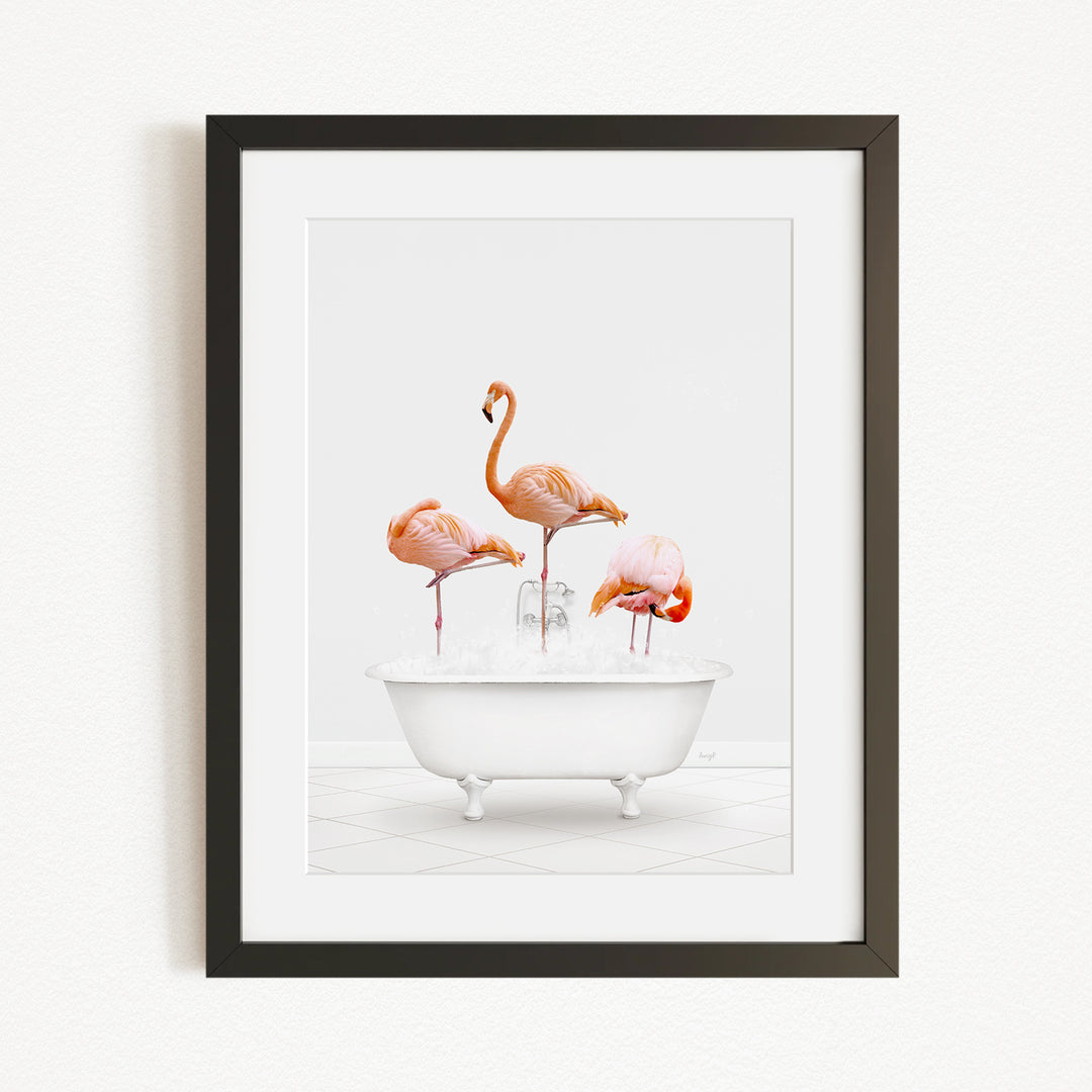 A framed image depicting three flamingos standing in a white bathtub filled with water.