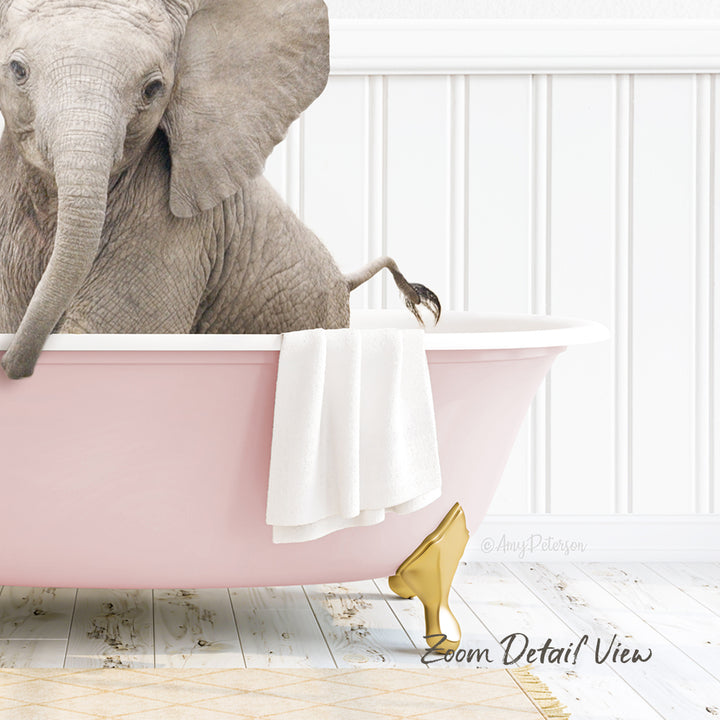 A gray elephant is sitting in a pink bathtub, with a white towel hanging on the side and a gold shoe placed on the floor next to the tub.
