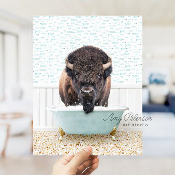 a hand holding up a card with a picture of a bison in a bathtub