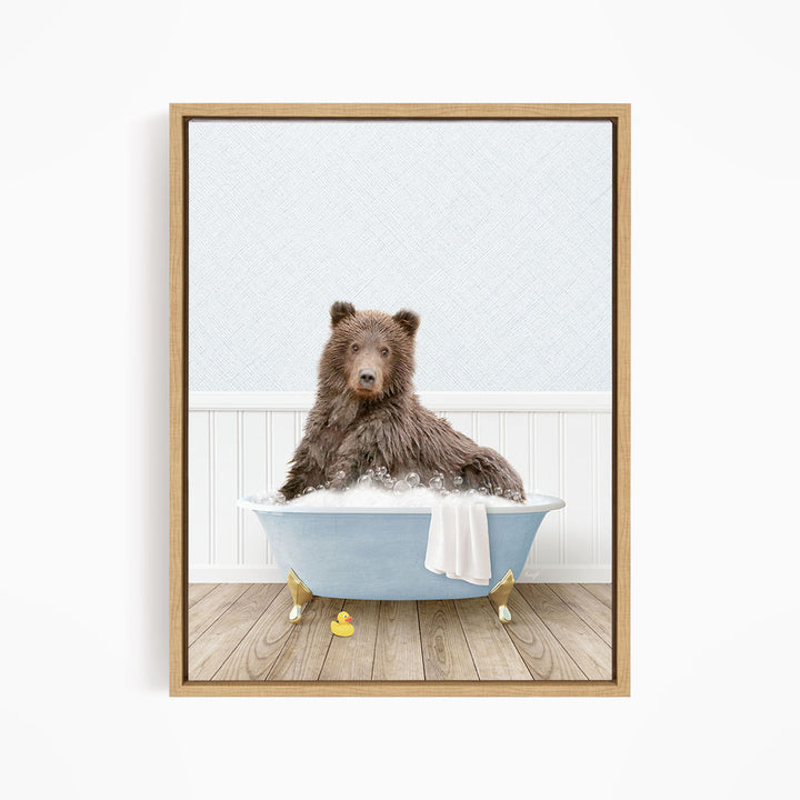 A brown bear sitting in a blue bathtub filled with water, surrounded by rubber ducks.