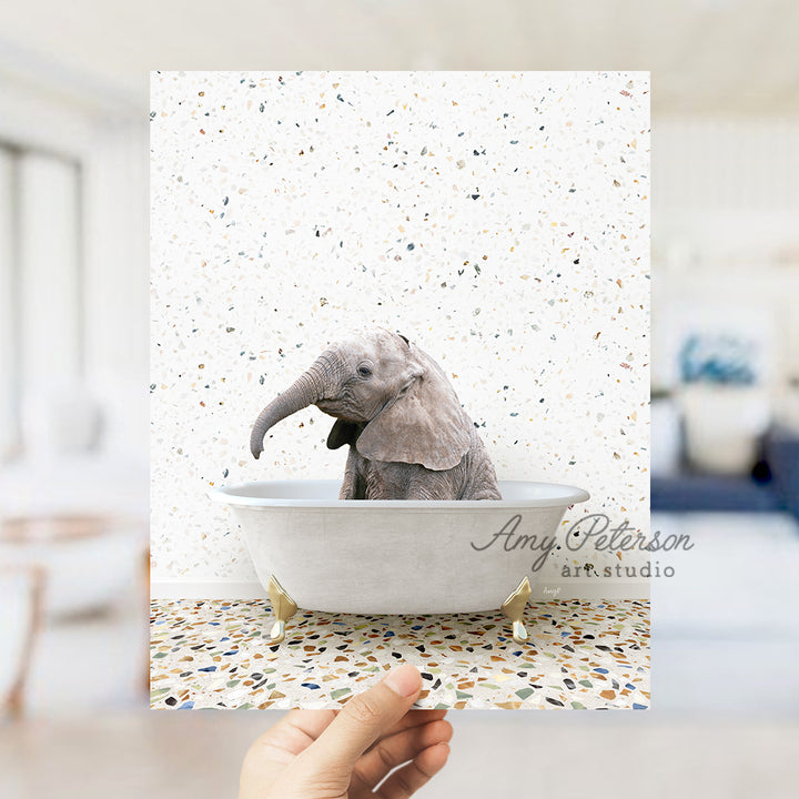 a hand holding up a card with an elephant in a bathtub