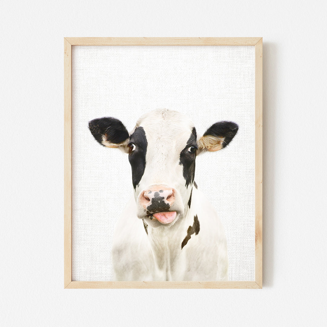 a picture of a cow is hanging on a wall