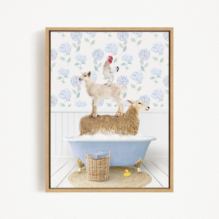 A framed image depicting a sheep standing on a tub filled with water, with a chicken perched on top of it, and a lamb sitting on the tub's edge. The background features a floral pattern.