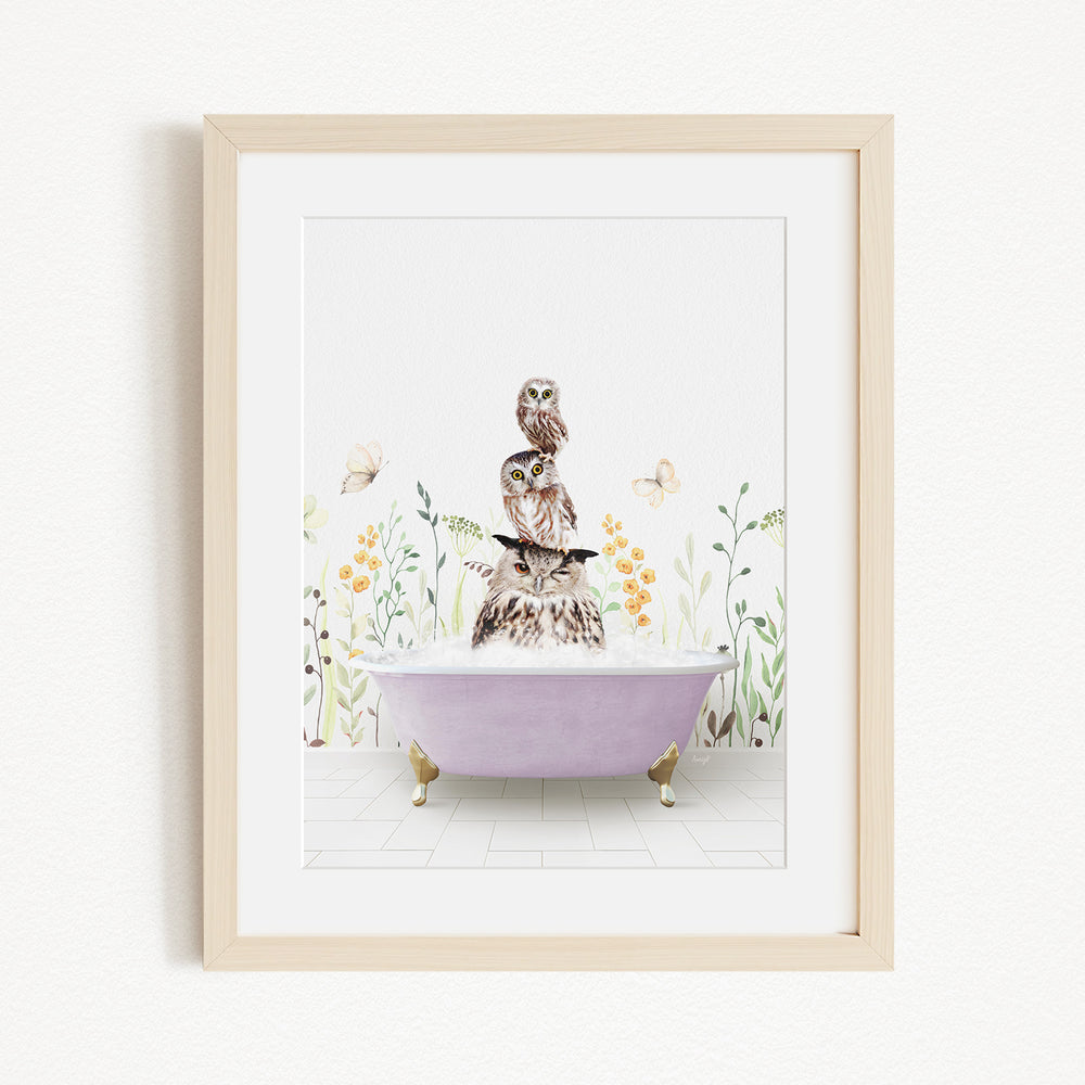 A framed print depicting a whimsical scene of a cat sitting on a purple bathtub, surrounded by flowers and butterflies.