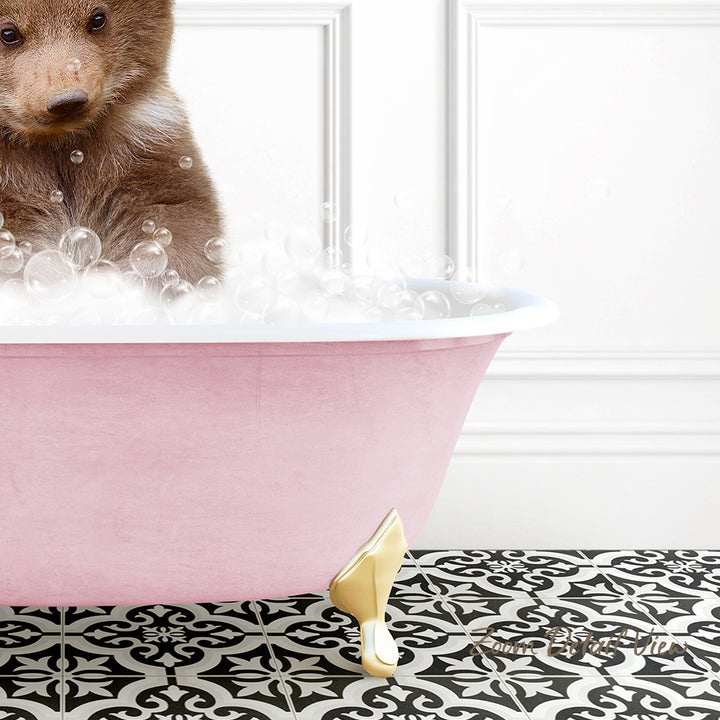 A brown bear is sitting in a pink bathtub filled with bubbles, creating a whimsical and playful scene.