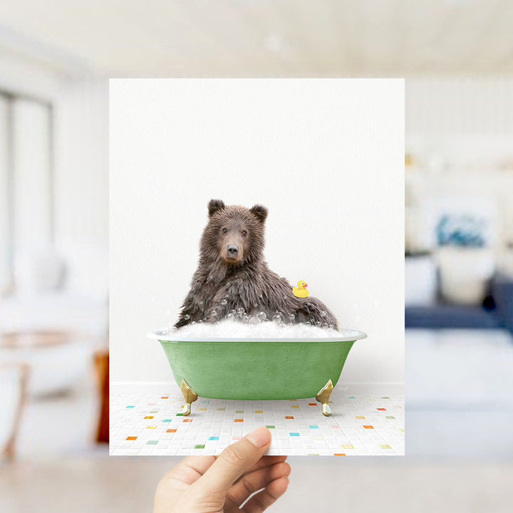 A brown bear sitting in a green bathtub filled with bubbles, with a yellow rubber duck floating nearby.