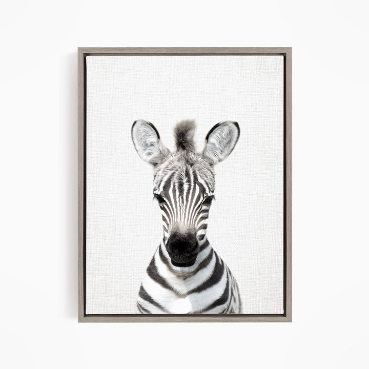 A black and white portrait of a zebra with its distinctive striped pattern and large ears.
