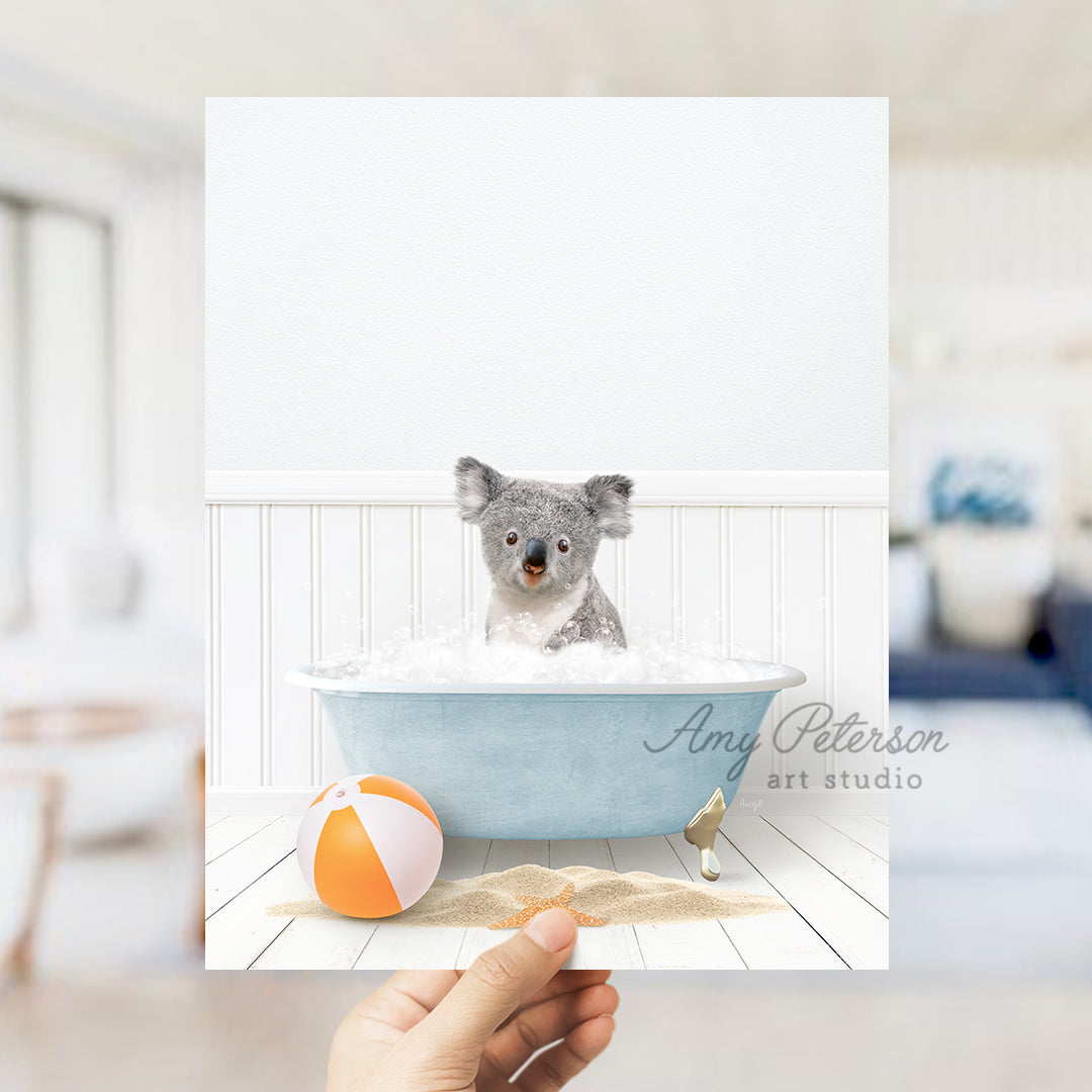 a person holding a photo of a koala in a bathtub