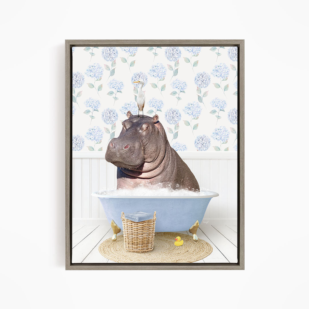 A hippopotamus sitting in a bathtub filled with water, surrounded by a basket of rubber ducks and a bird perched on its head.