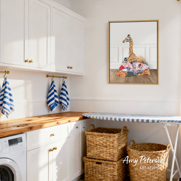 a cozy laundry room with white cabinets, a wooden countertop, and a framed artwork of a giraffe on the wall.