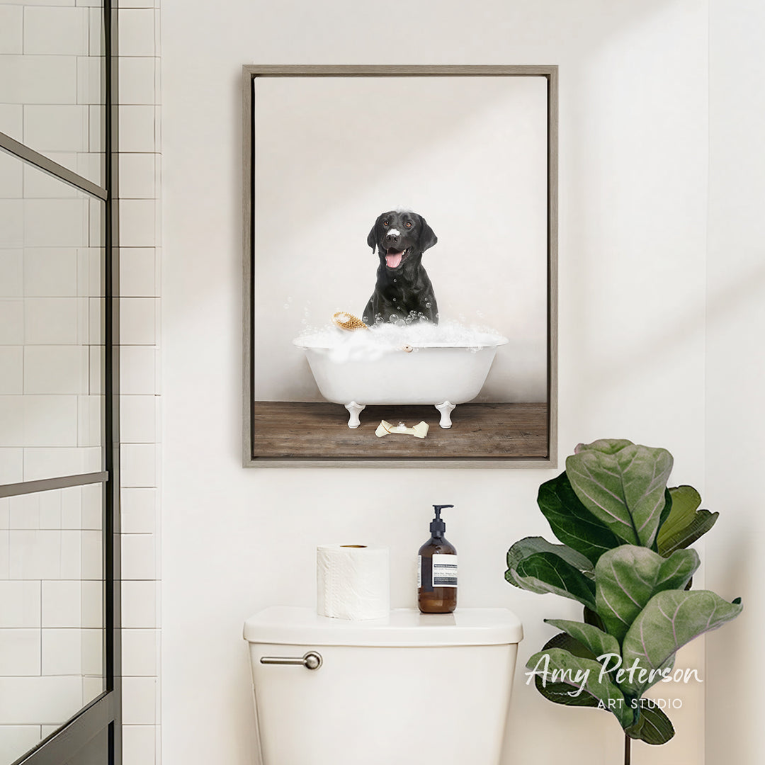 A framed image of a black dog sitting in a bathtub filled with bubbles, surrounded by a potted plant and toiletries in a bathroom setting.