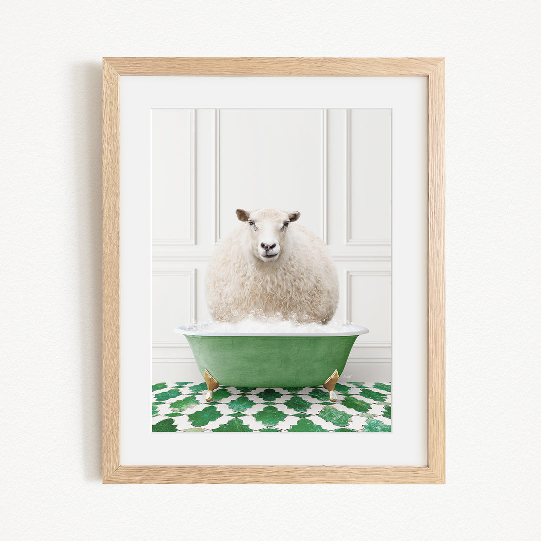 A fluffy white sheep sits in a green bathtub filled with bubbles, surrounded by a green and white patterned rug.