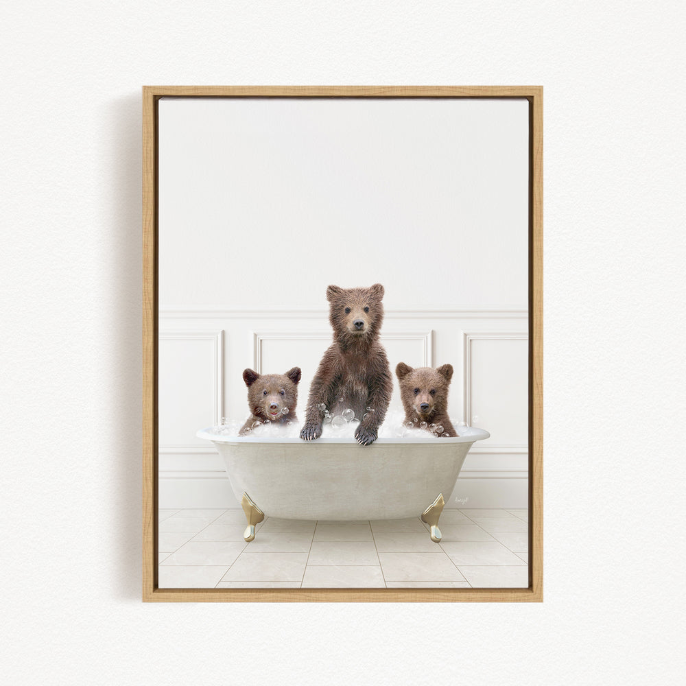 Three adorable brown bears sitting in a white bathtub, with one bear sitting on the edge of the tub and the other two bears sitting inside the tub.