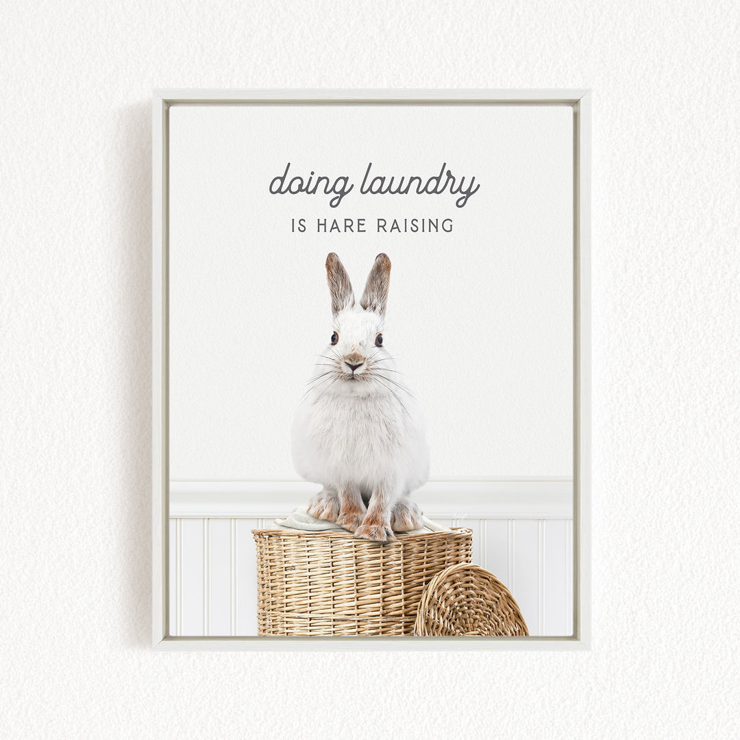 A white rabbit sitting on a woven basket, with the text "Doing laundry is Hare raising" displayed above the image.