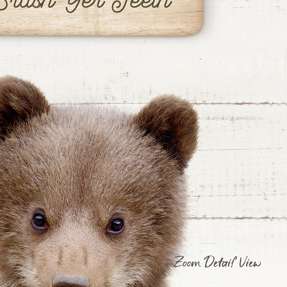 A close-up of a bear's face, with its large eyes and soft fur, is the main focus of the image.