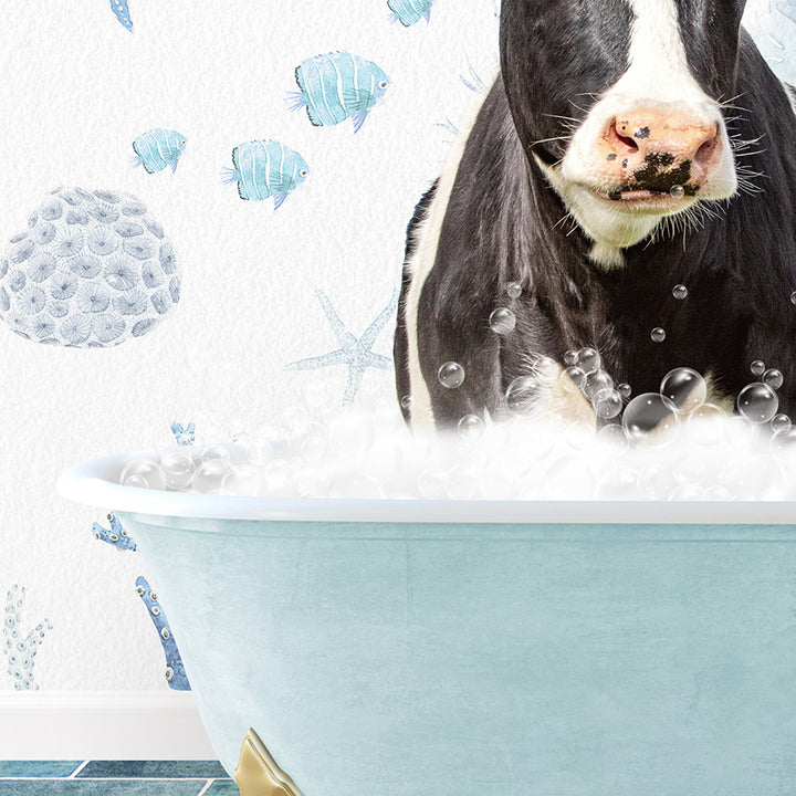 a black and white cow sitting in a bathtub filled with bubbles