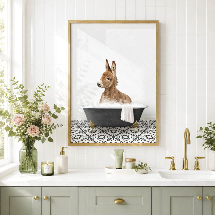 A framed image of a kangaroo sitting in a bathtub, surrounded by flowers and a decorative vase, is displayed on a white tiled wall above a bathroom sink.