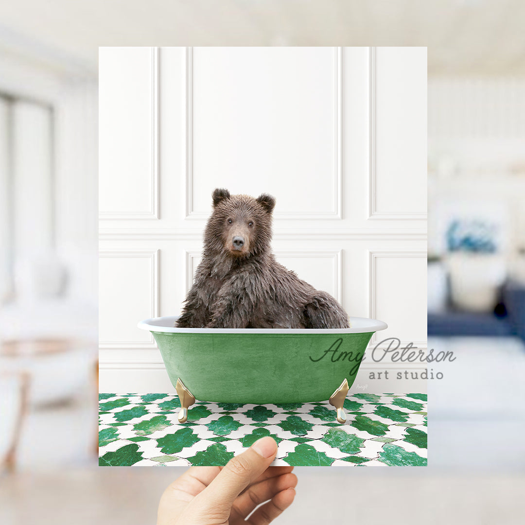 a hand holding a card with a picture of a bear in a bathtub