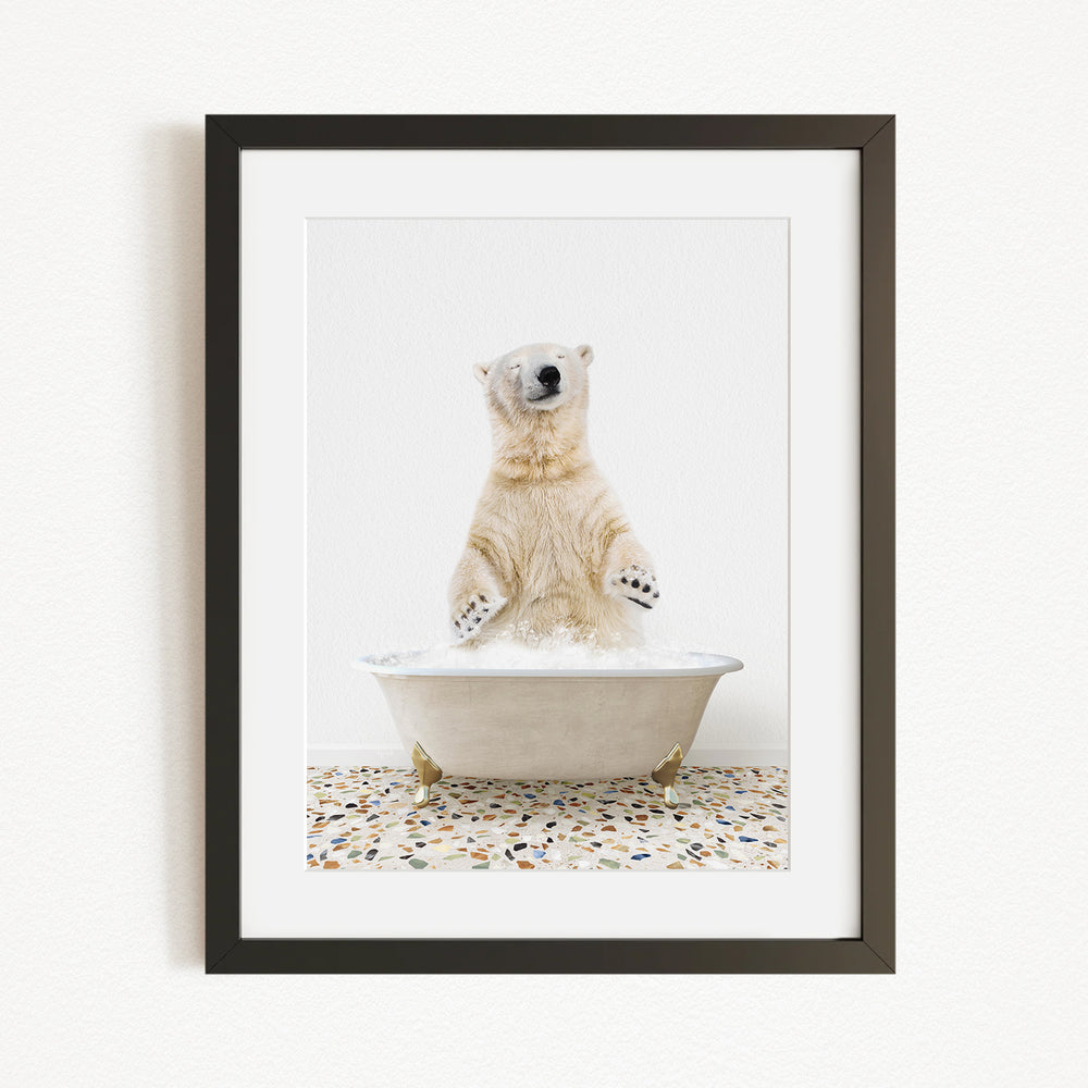 A polar bear standing in a bathtub filled with water, with its paws raised in the air.