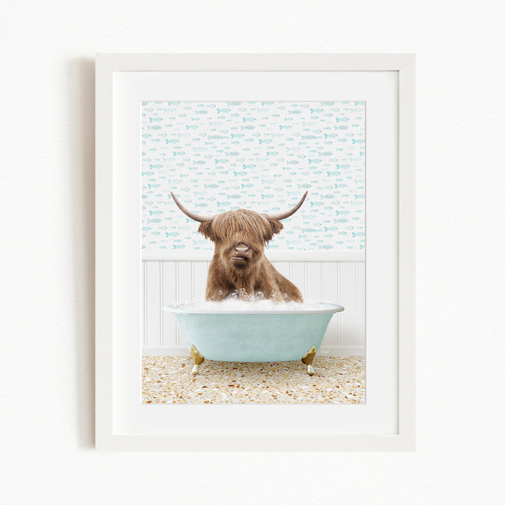 A brown cow with long horns is sitting in a light blue bathtub, surrounded by a patterned tile floor and a white wall with a blue and white fish wallpaper.