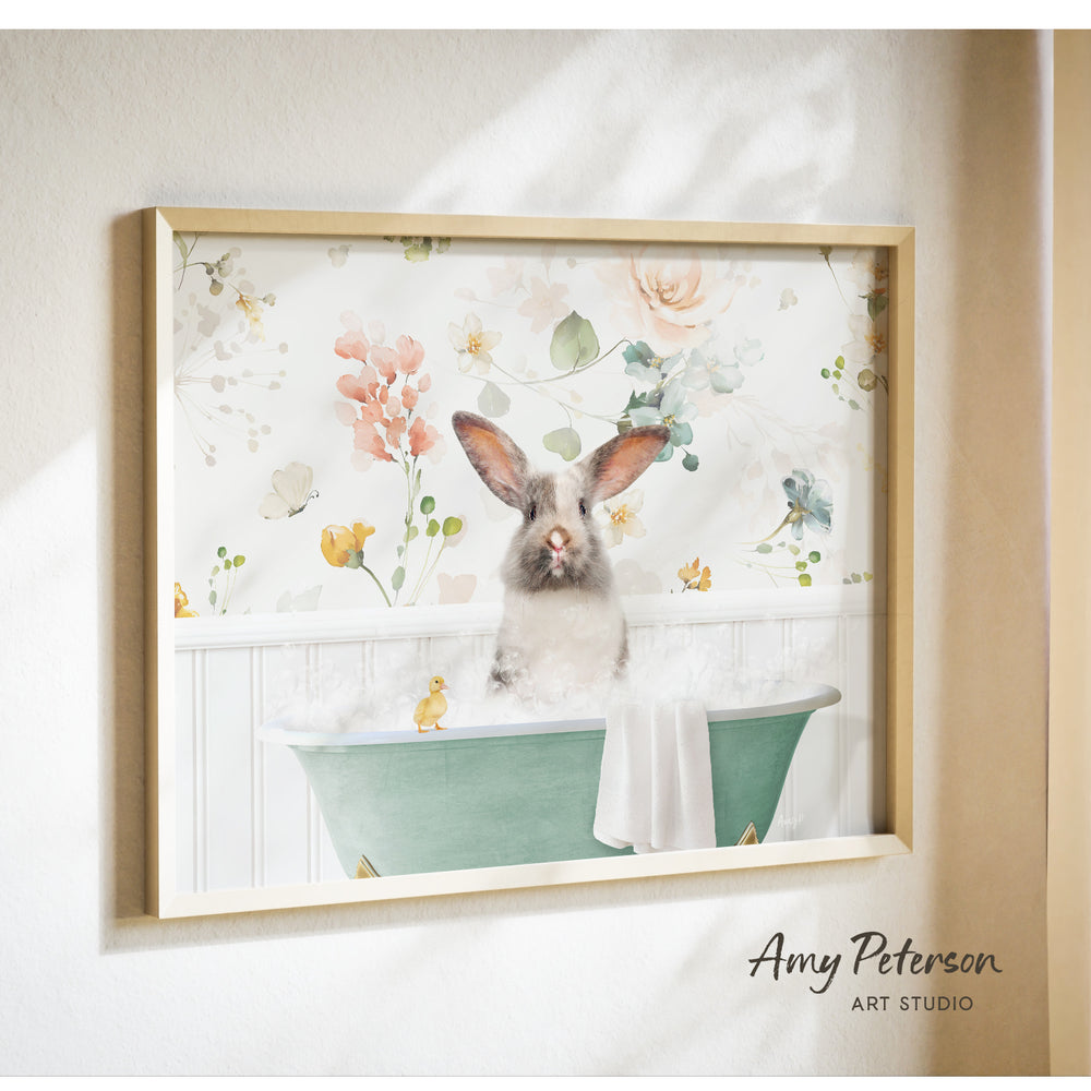 A framed print of a rabbit sitting in a bathtub filled with bubbles, surrounded by a floral pattern.