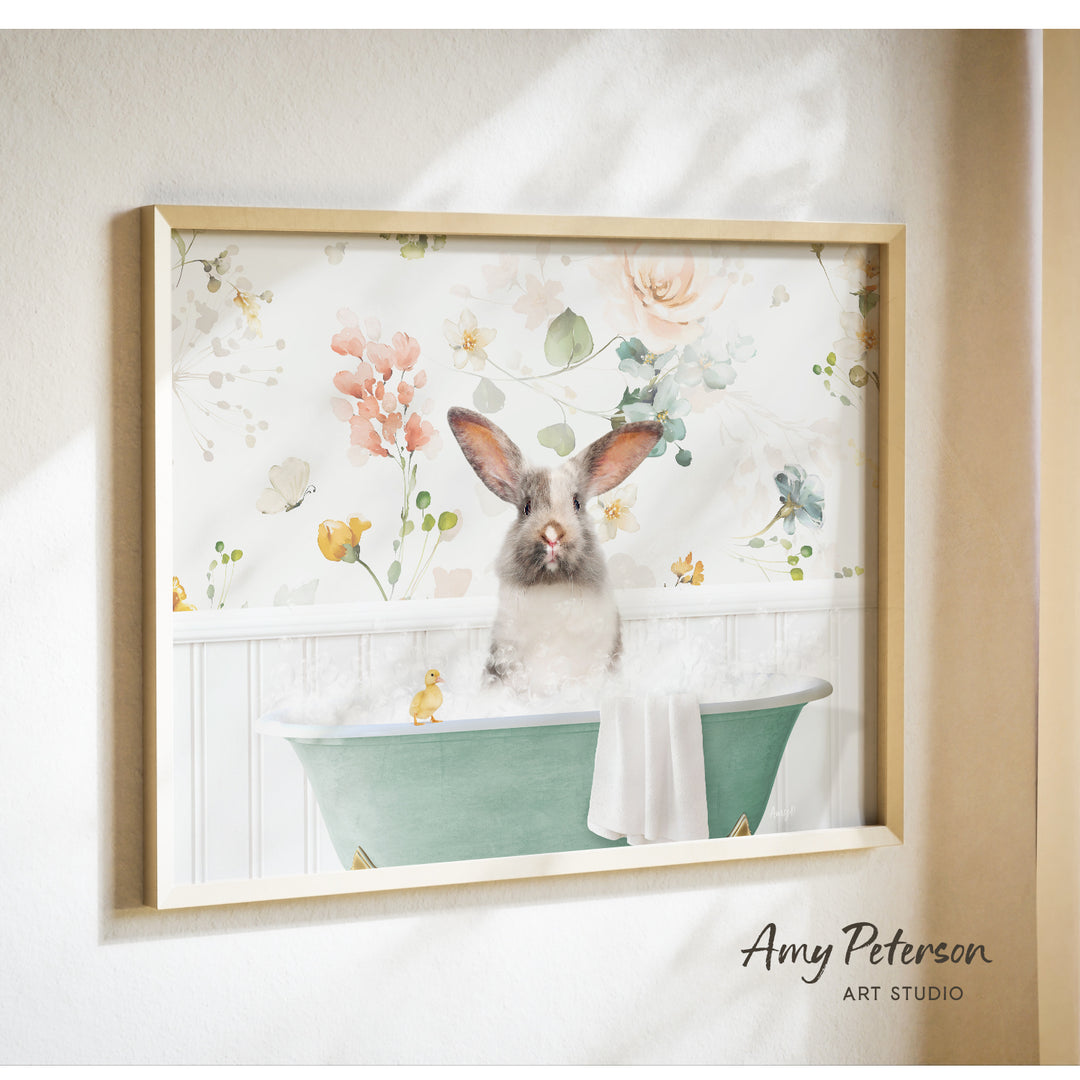 A framed print of a rabbit sitting in a bathtub filled with bubbles, surrounded by a floral pattern.