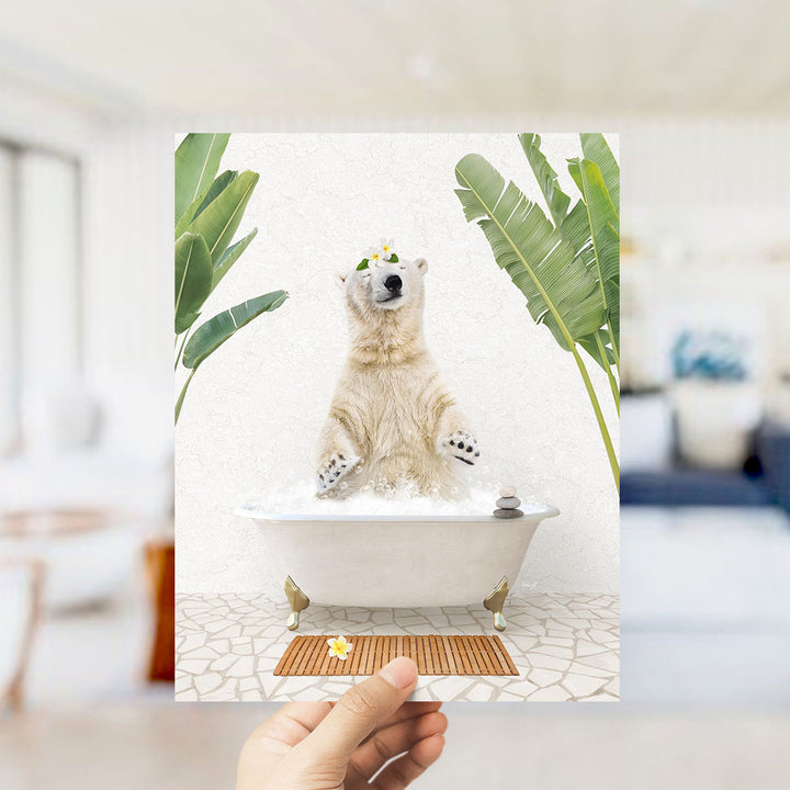 A polar bear sitting in a bathtub filled with water, surrounded by tropical plants, with a hand holding up the image.