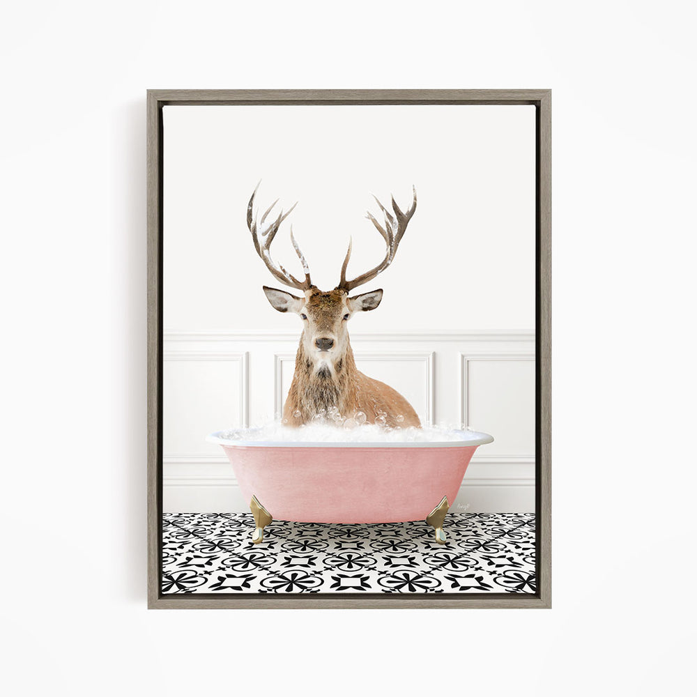 A deer with large antlers is sitting in a pink bathtub filled with water, creating a whimsical and unexpected scene.