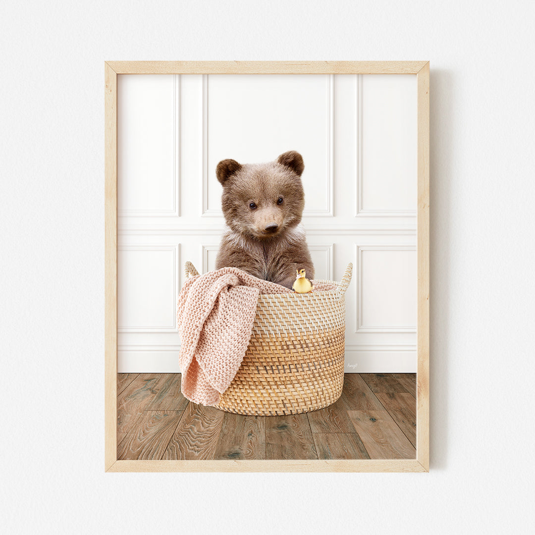 a brown teddy bear sitting in a basket