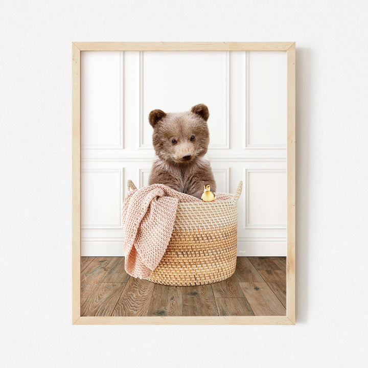 a brown teddy bear sitting in a basket