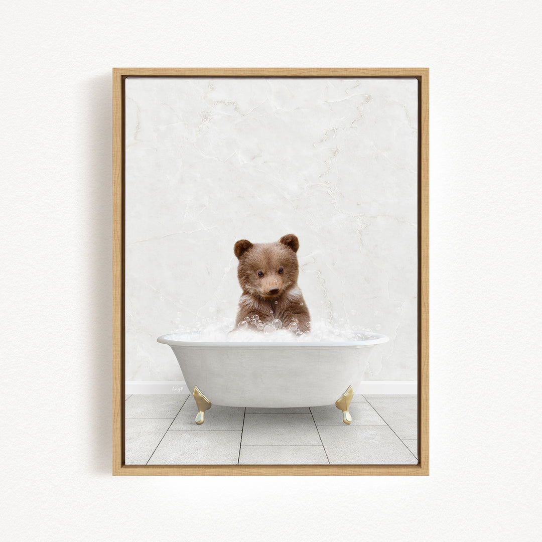 A brown bear sitting in a white bathtub filled with water, looking at the camera.