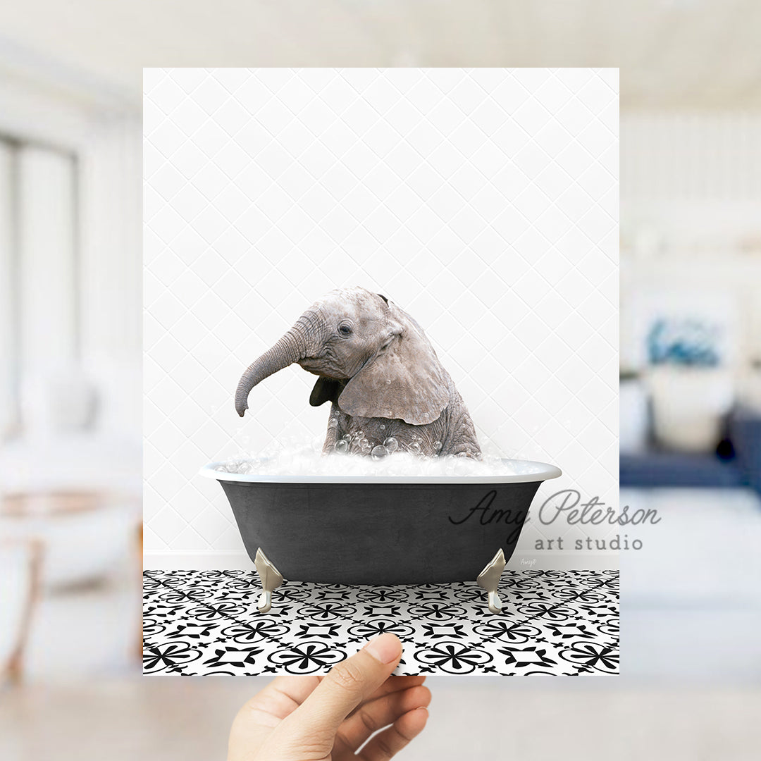 a person holding up a card with a picture of an elephant in a bathtub