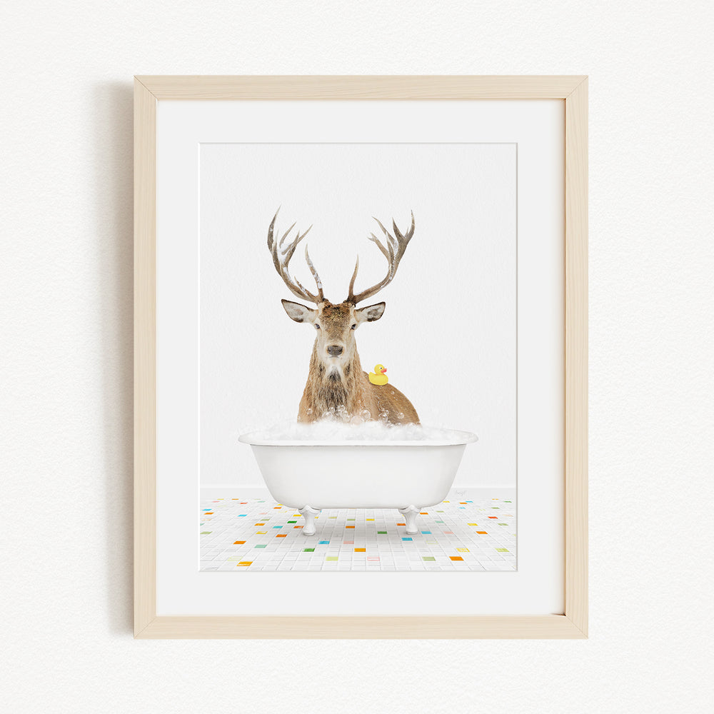 A deer with antlers is sitting in a white bathtub, with a yellow duck perched on its back.