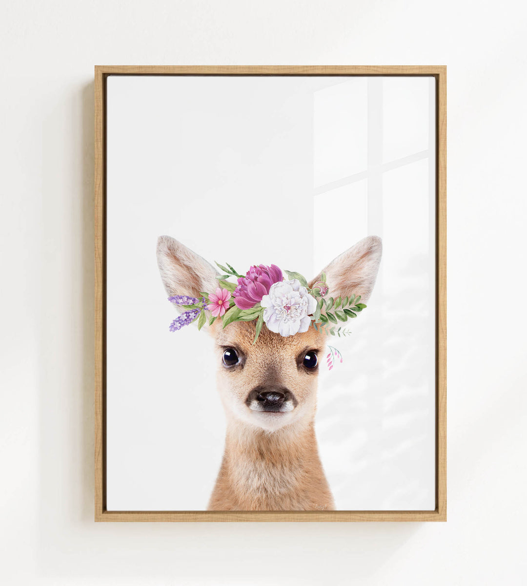 A deer wearing a flower crown is the focus of the image.