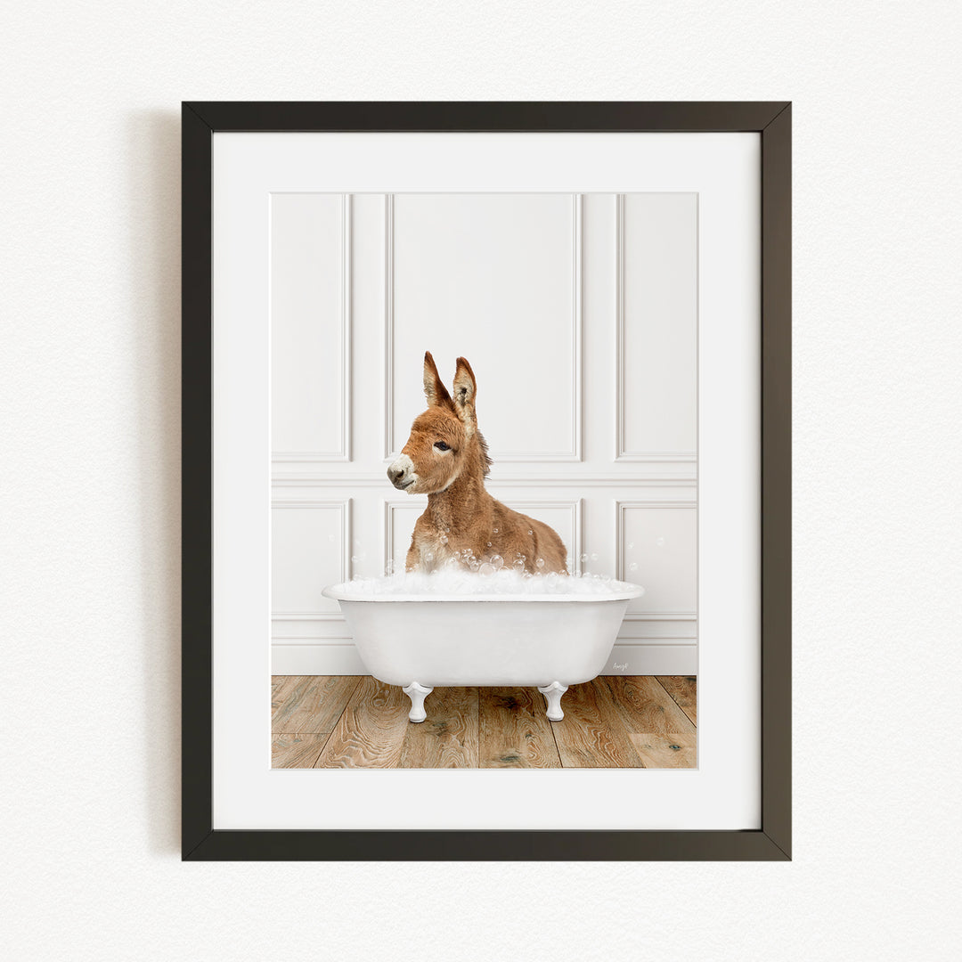 A donkey is sitting in a white bathtub filled with water, creating a playful and whimsical scene.