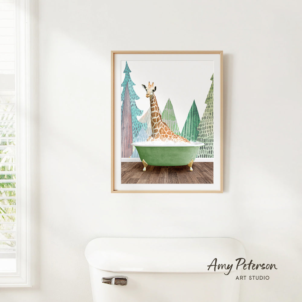 A framed painting of a giraffe sitting in a green bathtub, surrounded by trees, is hanging on a white wall.