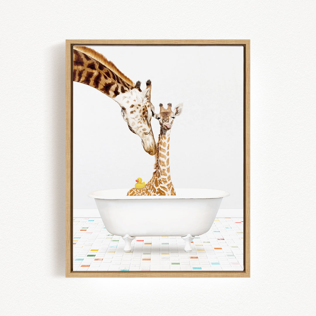A mother giraffe and her baby giraffe are sitting together in a white bathtub, with a yellow rubber duck floating in the water.