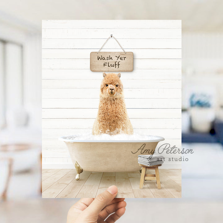 a hand holding a photo of a dog in a bathtub