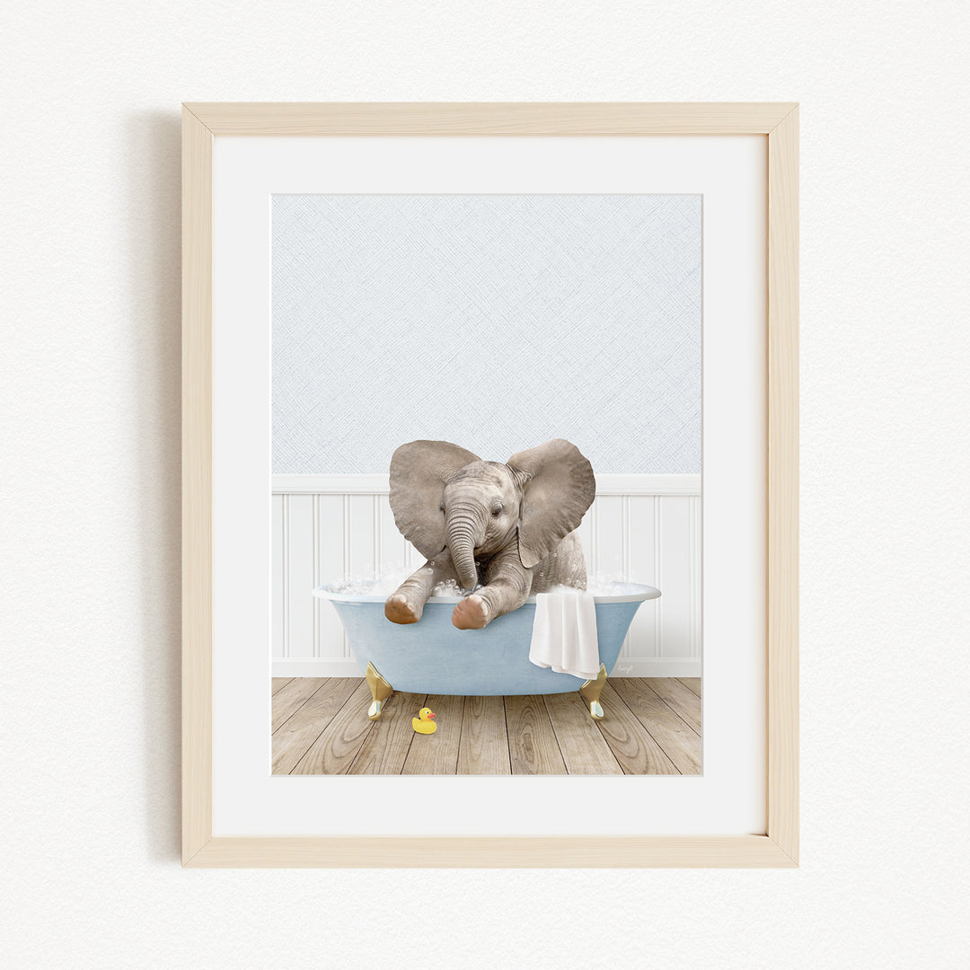 A baby elephant sitting in a blue bathtub, with its trunk curled up and ears flapping, against a white background.
