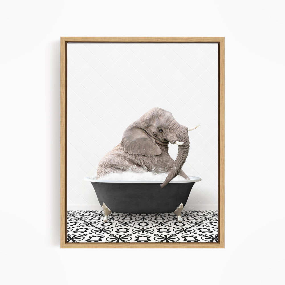 A gray elephant is sitting in a black bathtub filled with water, surrounded by a black and white patterned floor.