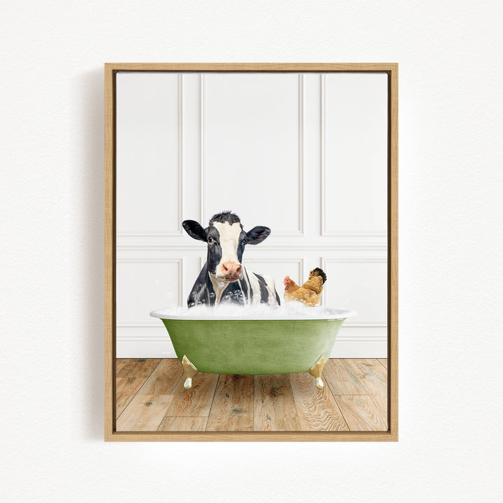A black and white cow is sitting in a green bathtub, with a chicken standing nearby, in a white-walled room with a wooden floor.