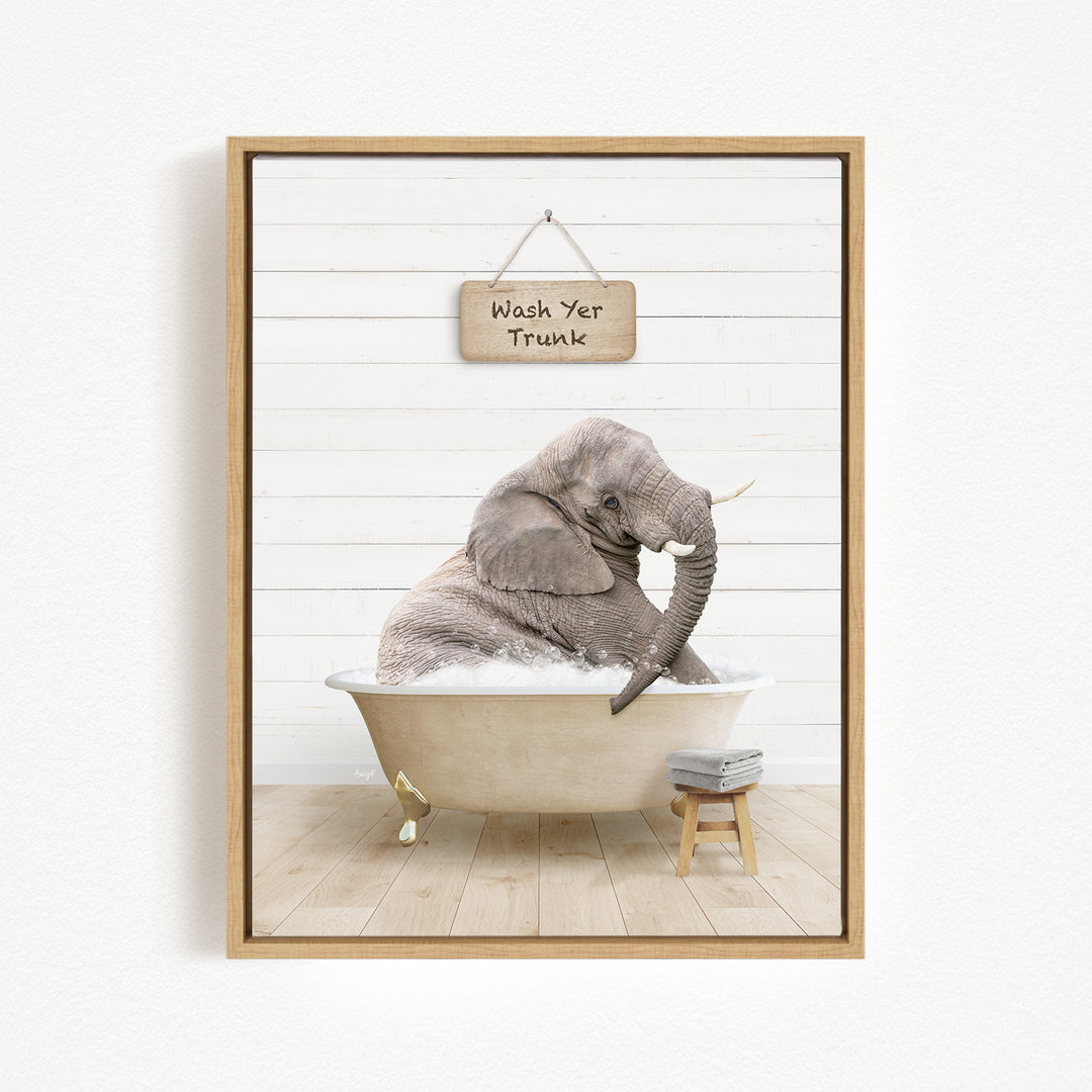 A gray elephant sitting in a bathtub, with a sign above it that says "Wash Yer Trunk".
