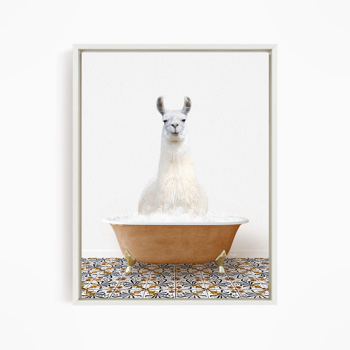 A white llama sitting in a bathtub filled with bubbles, with a patterned tile floor beneath it.
