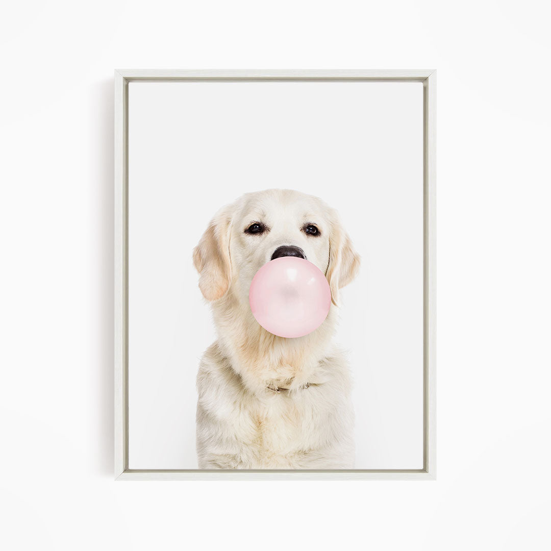A white dog is blowing a pink bubble with its mouth, creating a playful and adorable scene.