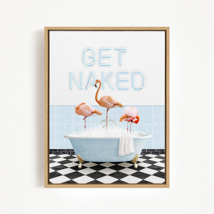 a framed print with a black and white checkered floor, a blue bathtub filled with bubbles, and three flamingos standing in the tub. The text "GET NAKED" is displayed above the flamingos.