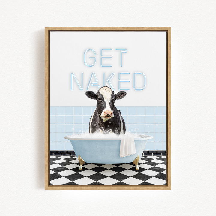 A cow sitting in a bathtub filled with water, with the text "GET NAKED" displayed above it.